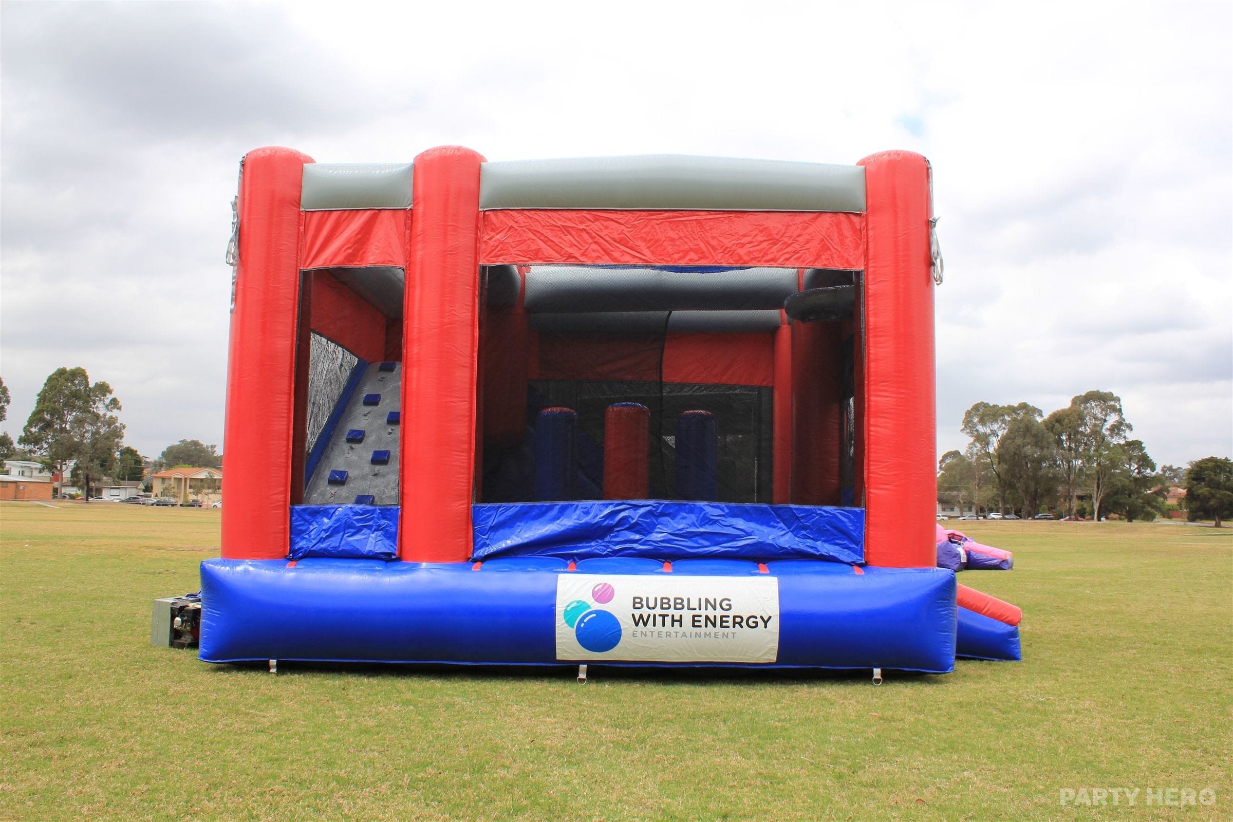 Jumping castle hire in Sydney — red and blue 5 in 1 combo castle with climbing wall and slide