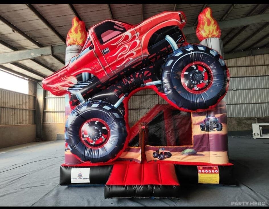 Monster truck jumping castle with a red truck on the roof