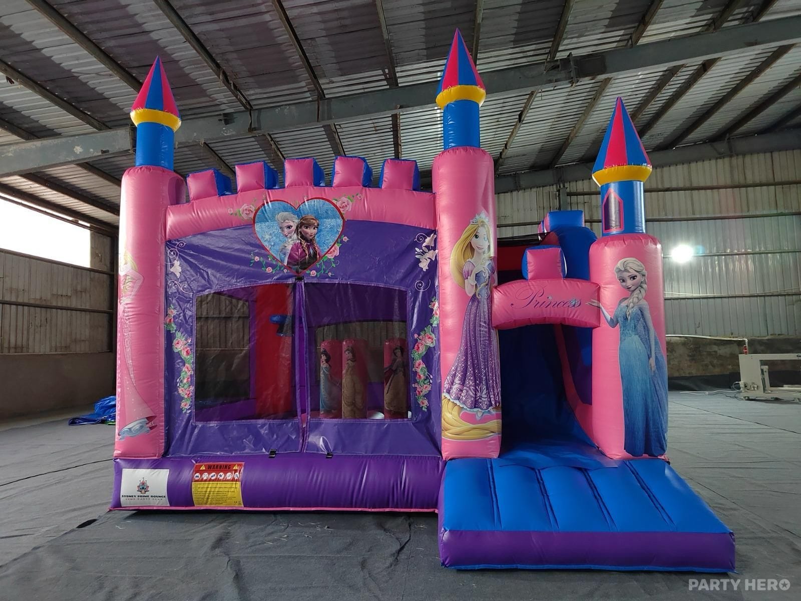 Pink and purple princess combo castle with a slide, branded Sydney Prime Bounce