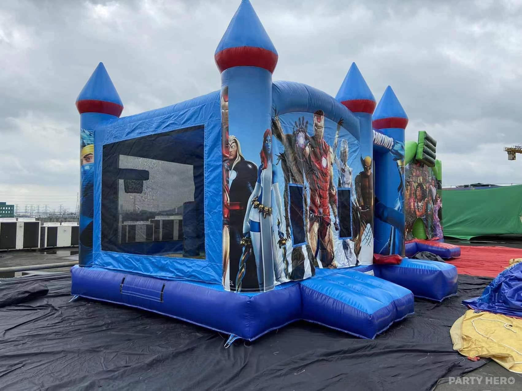 Blue superhero combo castle with turrets set up for hire