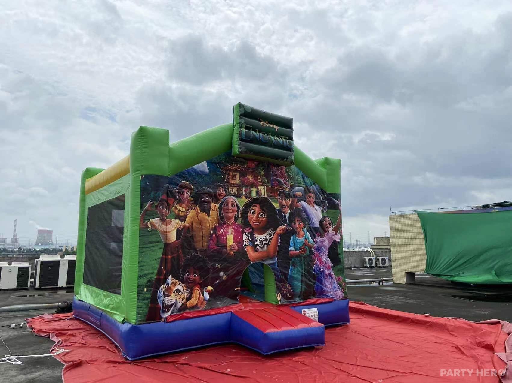 Encanto-themed jumping castle with green turrets