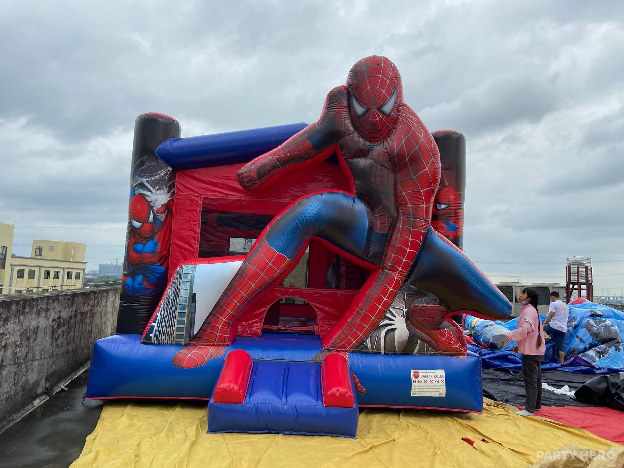 Spiderman combo castle with a slide set up on a rooftop event space